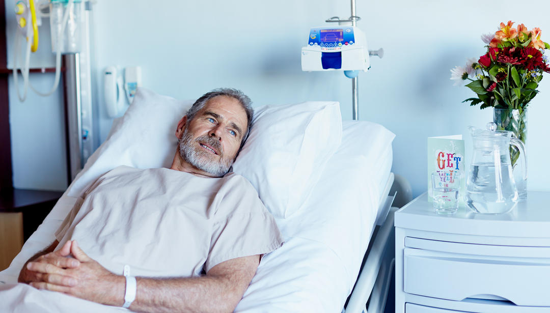 man in hospital bed