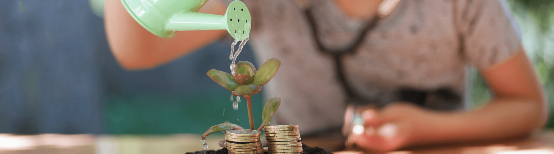 girl watering money plant