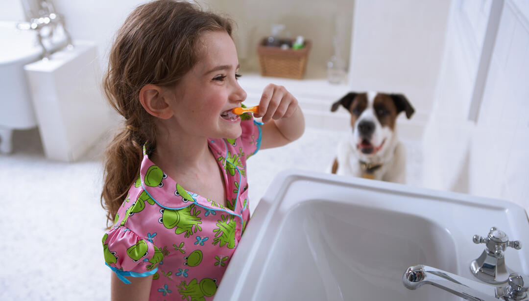 little girl brushing teeth