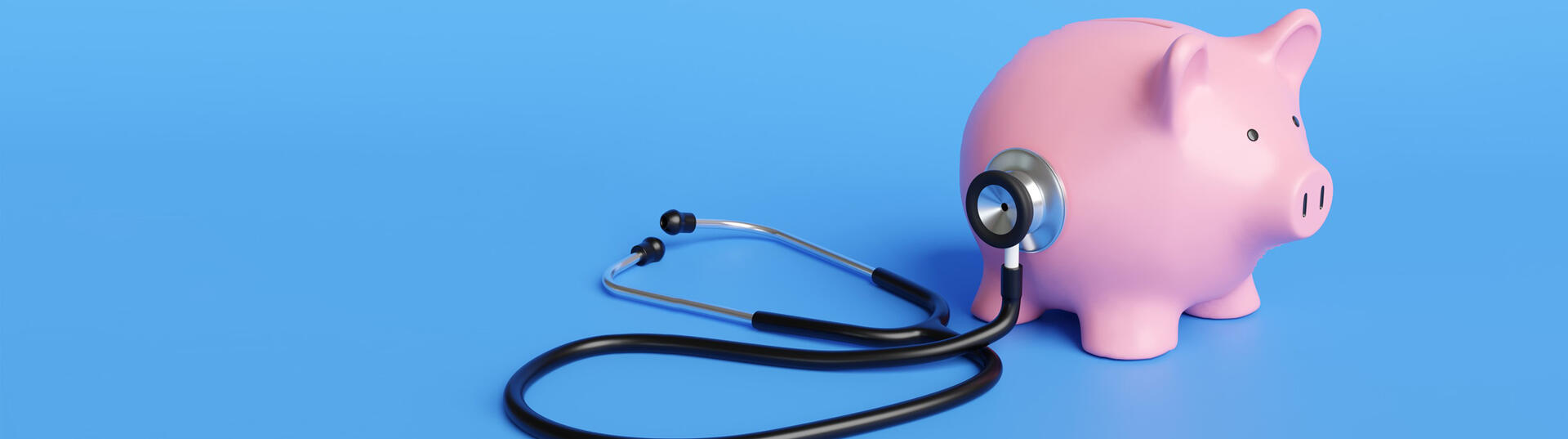 Black stethoscope on the body of a pink piggy bank in blue background