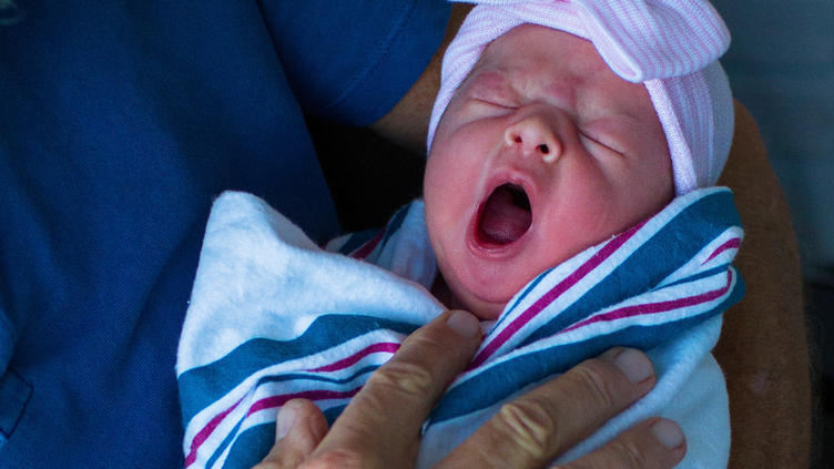 tiny baby just born while yawning